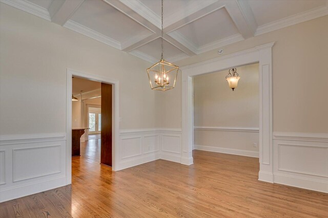 empty room featuring beamed ceiling, ornamental molding, and coffered ceiling