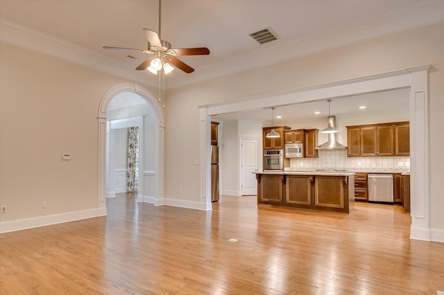 unfurnished living room with ceiling fan, ornamental molding, and light hardwood / wood-style flooring