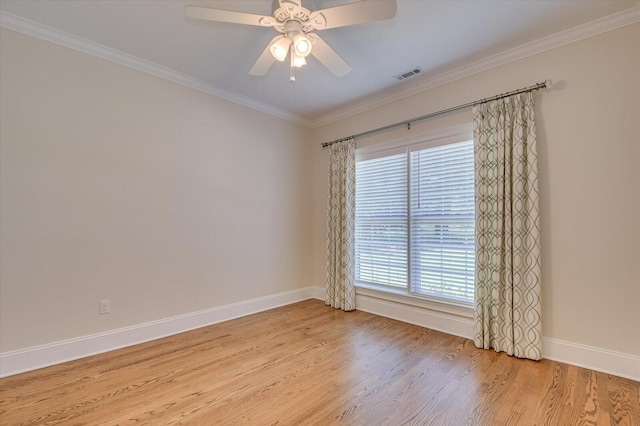 unfurnished room featuring plenty of natural light, ceiling fan, light wood-type flooring, and crown molding