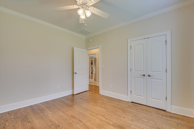 unfurnished bedroom with ceiling fan, a closet, light wood-type flooring, and ornamental molding