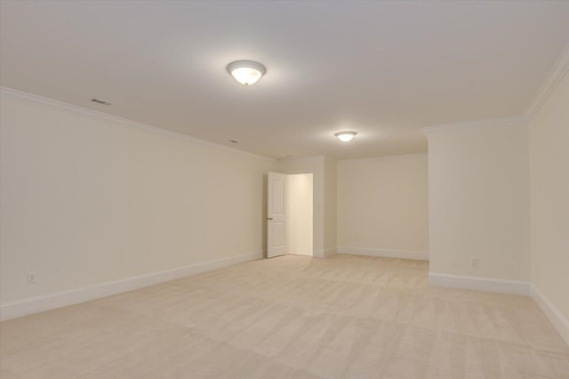 empty room featuring crown molding and light carpet