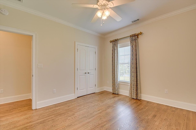 unfurnished bedroom featuring a closet, ceiling fan, crown molding, and light hardwood / wood-style floors