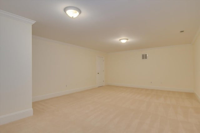 carpeted spare room featuring crown molding