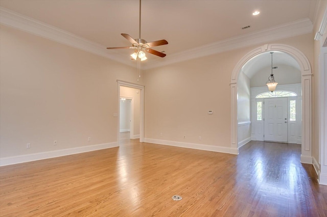 interior space featuring light wood-type flooring, ceiling fan, and ornamental molding