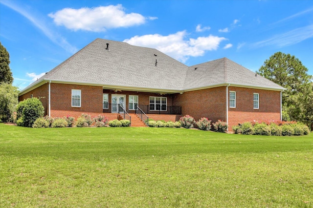 back of house with a lawn and ceiling fan