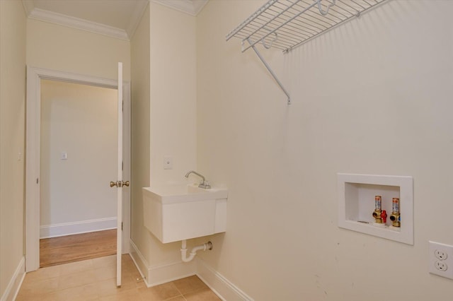 laundry room with hookup for a washing machine, ornamental molding, and sink