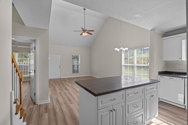 kitchen featuring light wood finished floors, white cabinets, dark countertops, ceiling fan with notable chandelier, and white dishwasher