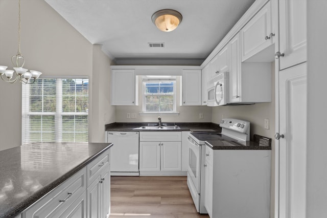 kitchen featuring visible vents, a sink, white appliances, light wood-style floors, and white cabinetry