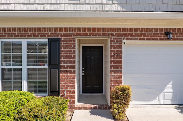 doorway to property with brick siding