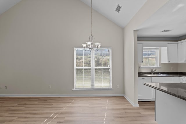 unfurnished dining area featuring lofted ceiling, a notable chandelier, visible vents, and light wood-style floors