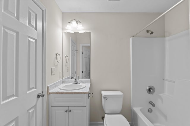 bathroom featuring toilet, vanity, and  shower combination