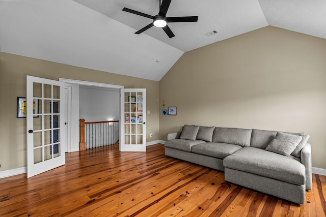 living room with vaulted ceiling, french doors, ceiling fan, and wood-type flooring