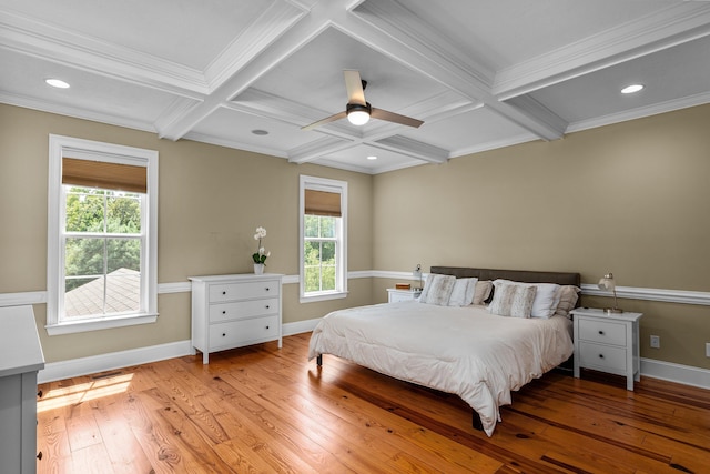 bedroom with ceiling fan, coffered ceiling, multiple windows, and beamed ceiling