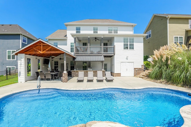 view of pool with a patio, ceiling fan, and exterior bar