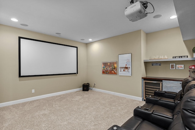 carpeted home theater featuring wine cooler