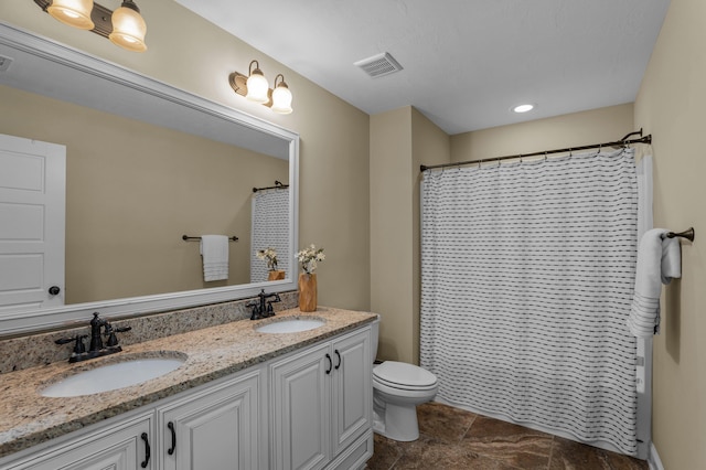 bathroom featuring toilet, walk in shower, and vanity