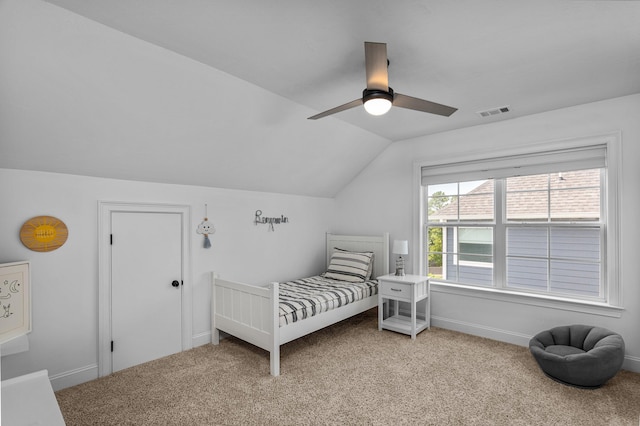 carpeted bedroom with ceiling fan and vaulted ceiling