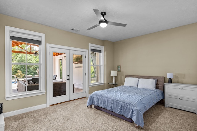 bedroom featuring a textured ceiling, french doors, access to exterior, ceiling fan, and light colored carpet