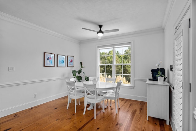 dining room with hardwood / wood-style floors, ceiling fan, and ornamental molding