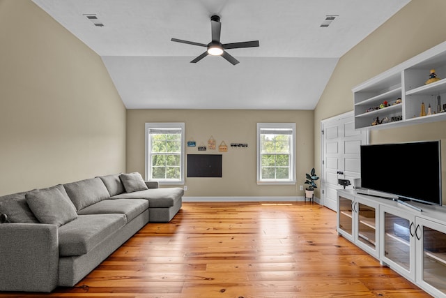 living room featuring vaulted ceiling, ceiling fan, light hardwood / wood-style floors, and a wealth of natural light