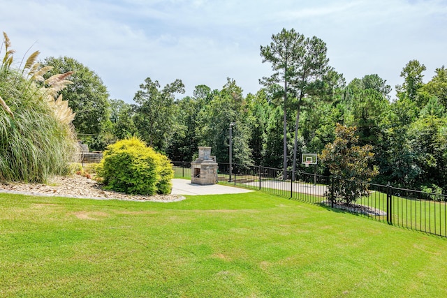 view of yard with an outdoor stone fireplace