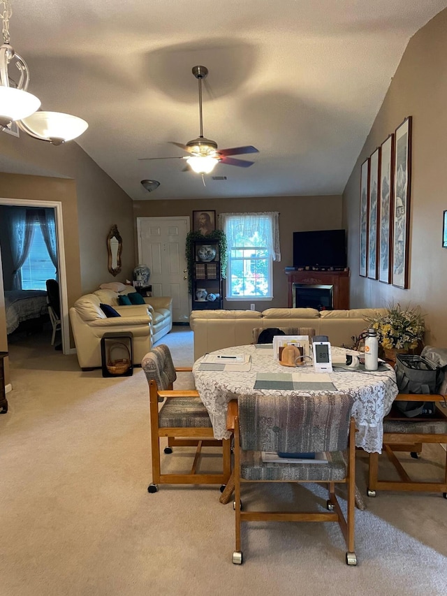 1036 Old Marks Dr, Augusta, GA 30909 - carpeted dining room with lofted ceiling, ceiling fan, and a fireplace