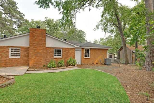 227 Chatham Rd, Augusta, GA 30907 - rear view of house with central AC unit, brick siding, and a chimney