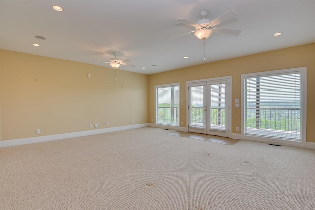 spare room with light carpet, baseboards, ceiling fan, and recessed lighting