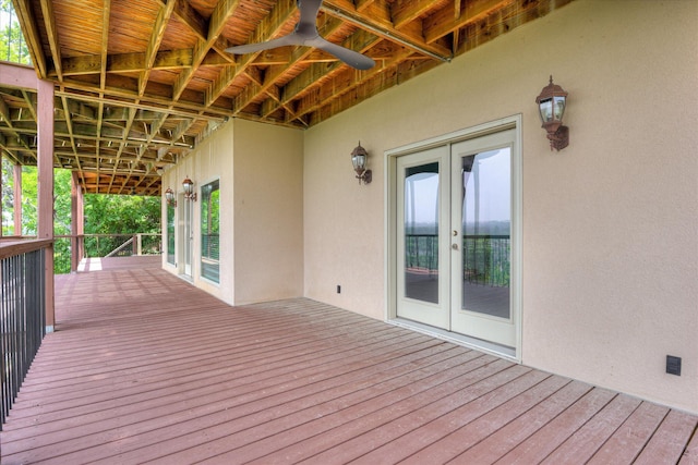 wooden terrace with french doors and a ceiling fan