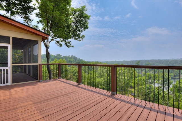 wooden deck with a sunroom