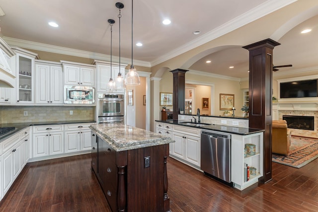 3820 Blue Springs Trce, Evans, GA 30809 - kitchen featuring appliances with stainless steel finishes, decorative columns, a sink, a kitchen island, and arched walkways