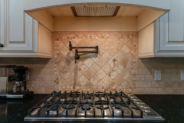 3820 Blue Springs Trce, Evans, GA 30809 - kitchen featuring stainless steel gas cooktop, arched walkways, backsplash, and dark stone countertops
