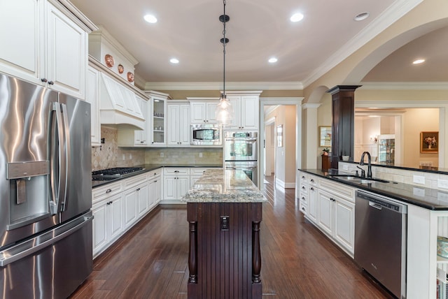 3820 Blue Springs Trce, Evans, GA 30809 - kitchen featuring appliances with stainless steel finishes, a sink, a center island, white cabinetry, and ornamental molding