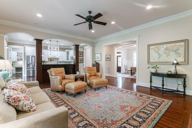 3820 Blue Springs Trce, Evans, GA 30809 - living area with ornate columns, arched walkways, ceiling fan, dark wood-style flooring, and ornamental molding