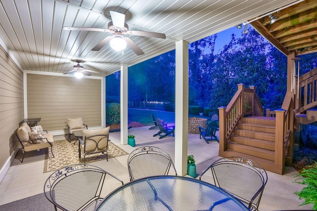 3820 Blue Springs Trce, Evans, GA 30809 - patio at night featuring outdoor dining area, ceiling fan, a patio, and stairway