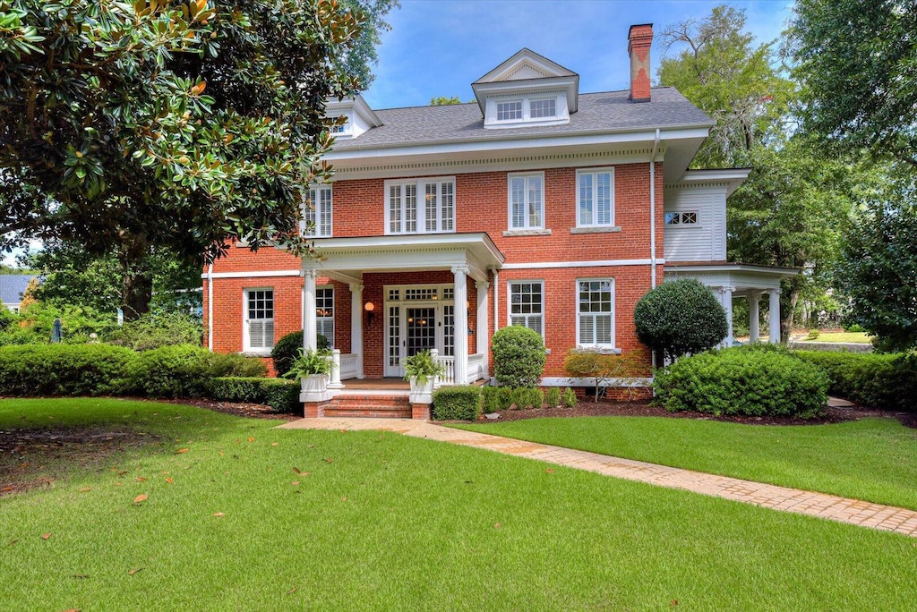 colonial-style house with a front lawn