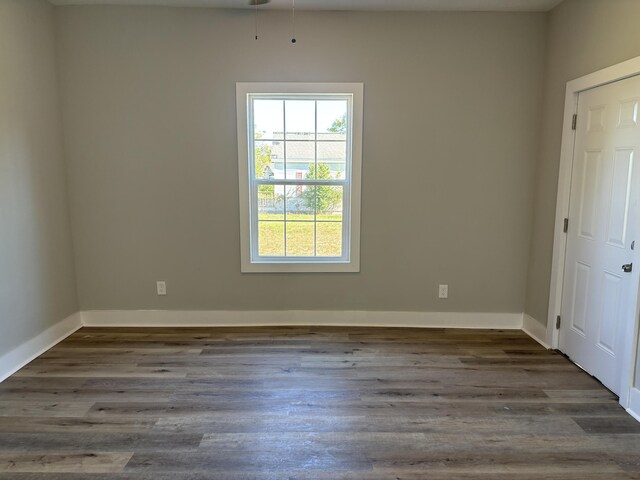 empty room featuring dark wood-type flooring