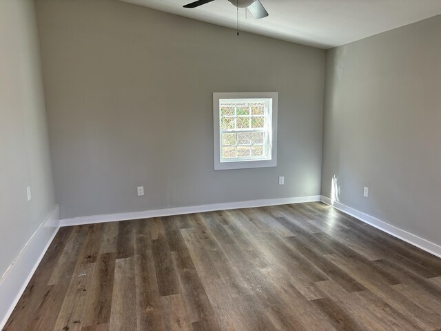 empty room with dark hardwood / wood-style floors and ceiling fan