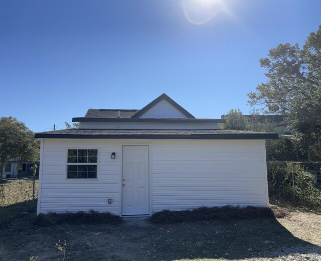 rear view of property with an outdoor structure