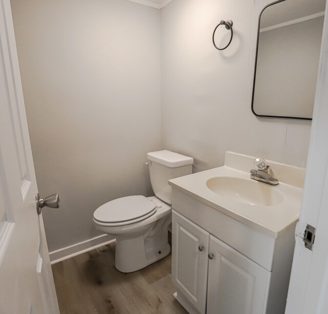 bathroom featuring hardwood / wood-style floors, vanity, and toilet