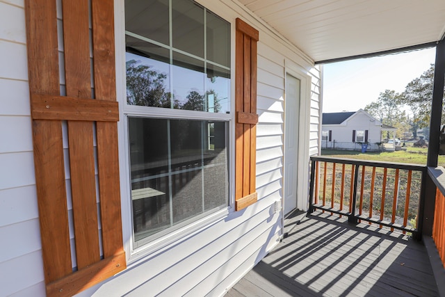 wooden terrace featuring covered porch