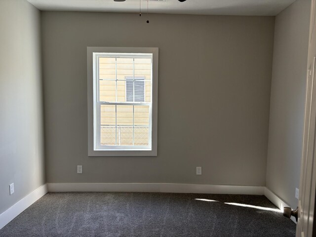 unfurnished room with a wealth of natural light, carpet, and ceiling fan