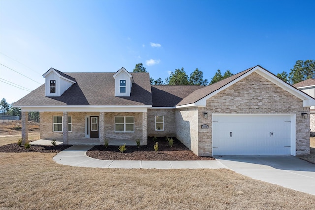 view of front facade with a garage, a front lawn, and covered porch