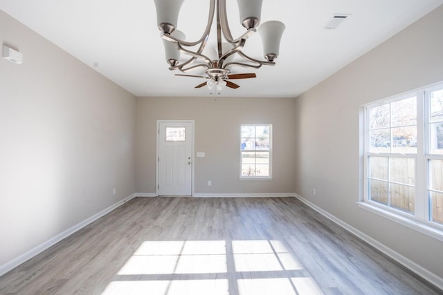 foyer featuring light hardwood / wood-style flooring and an inviting chandelier