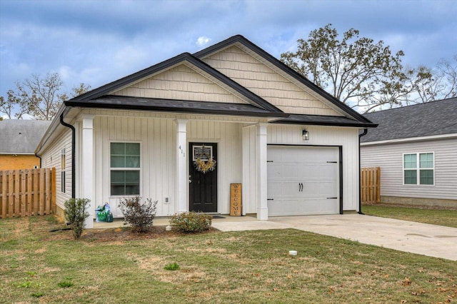 view of front of house with a front yard and a garage