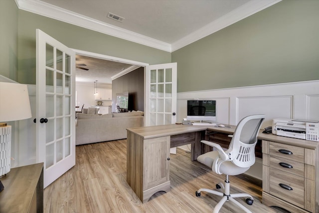 home office featuring crown molding, visible vents, french doors, and light wood-style flooring