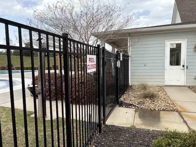view of gate featuring a fenced in pool and fence