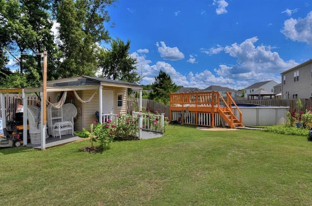 back of house featuring a pool side deck and a yard