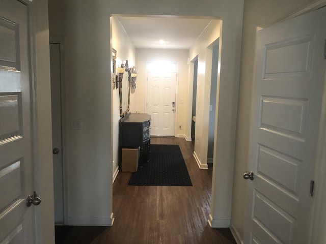 corridor with dark wood-type flooring