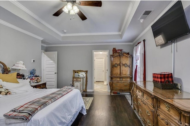 bedroom featuring ceiling fan, ornamental molding, dark hardwood / wood-style floors, and a raised ceiling